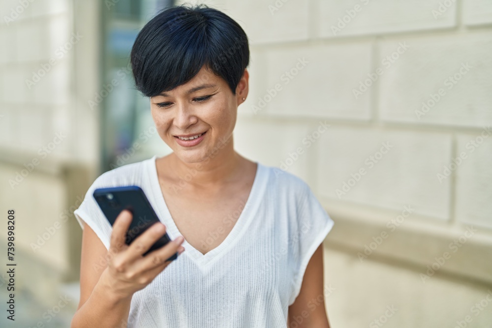 Middle age chinese woman smiling confident using smartphone at street Middle age chinese woman smiling confident using smartphone at street