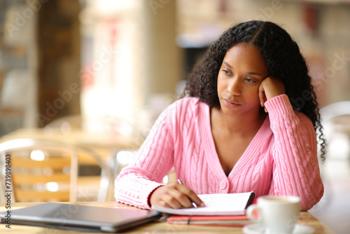 Tableau sur toile Black distracted apathetic student in a coffee shop