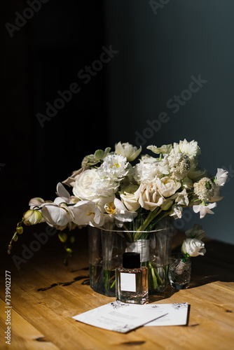 beautiful modern wedding bouquet of white flowers, orchids in a transparent vase