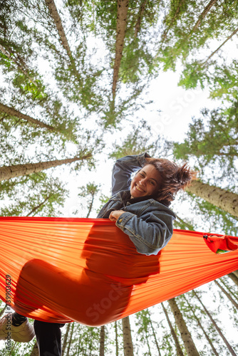 happy woman on hammock in the forest