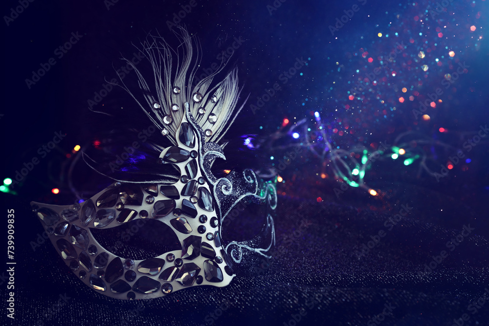 Photo of elegant and delicate Venetian mask over black background