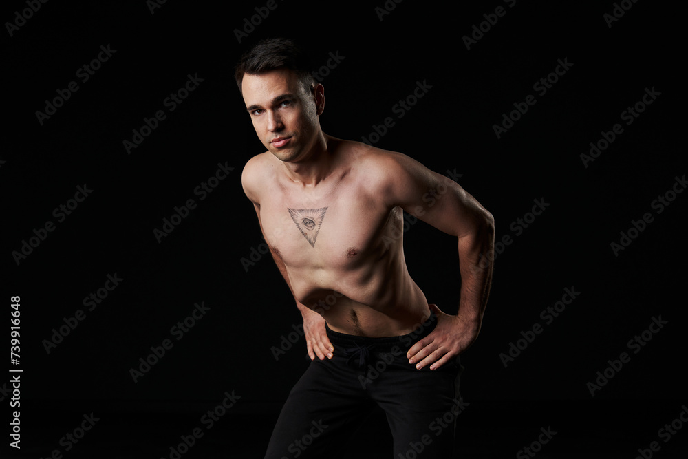 Yogic man practices abdominal vacuum technique for core strength. Yogic man practices abdominal vacuum technique for core strength.