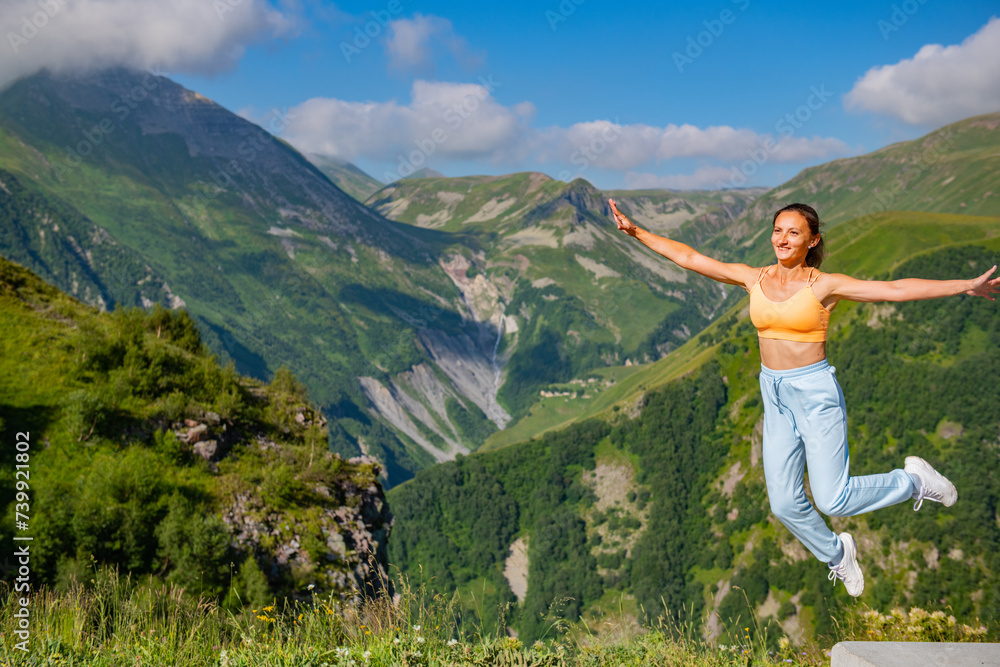 Admiring Mountain Scenery: One Girl in Blue Suit Surrounded by Lush Greenery and Blue Sky