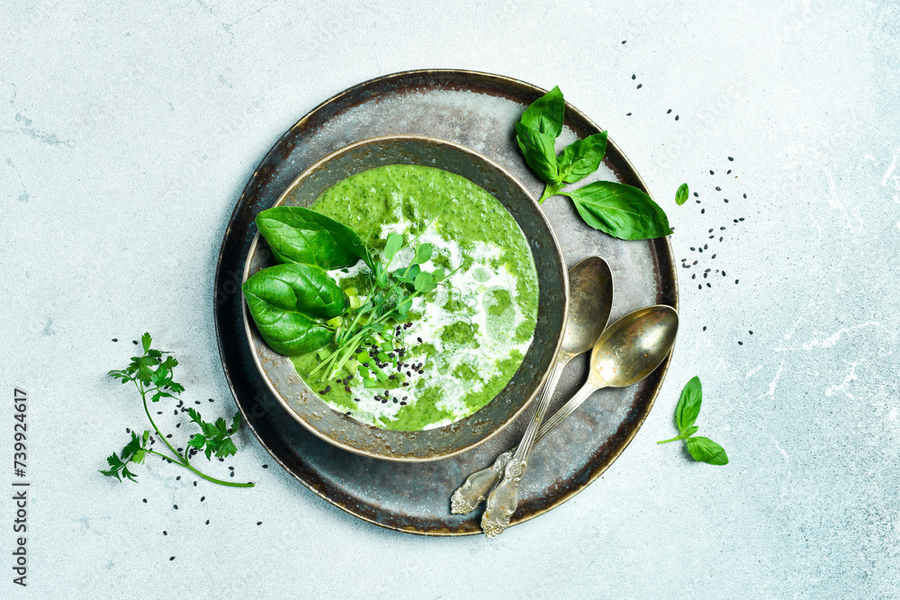 Vegan Spinach cream soup with cream. In a bowl. The concept of vegetarian food. Vegan Spinach cream soup with cream. In a bowl. The concept of vegetarian food.