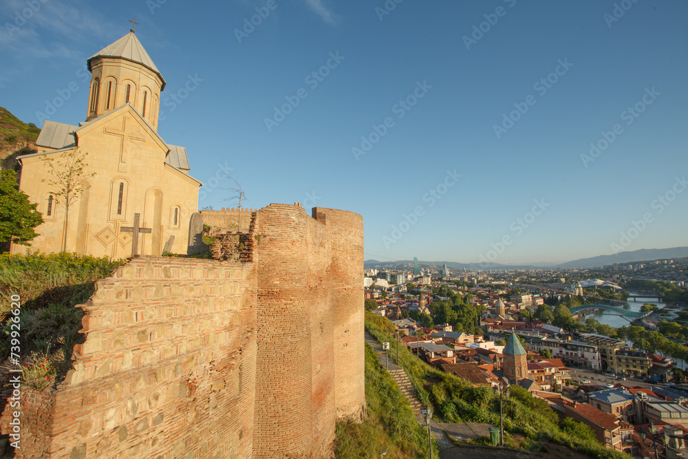 The Virgin Mary Assumption Church of Metekhi in Tbilisi on the background of city panorama