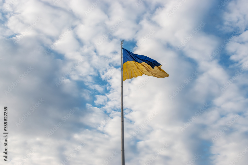 Ukrainian flag waving in the wind against the sky. Ukrainian flag waving in the wind against the sky.