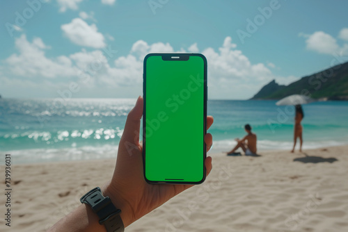 Mockup of an iPhone with a green screen, hand holding an iPhone, on the beach