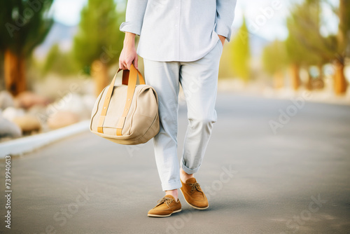 boy in a linen shirt, rollup trousers, and moccasins with a canvas messenger bag