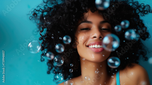 curly haired African American woman rinsing shampoo out of her hair photo