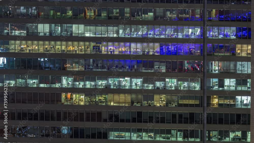 Frontal view of night facade of business tower building with a lot of windows with light timelapse. Life in every window. Aerial view of the glass facade of an office skyscraper. Frontal view of night facade of business tower building with a lot of windows with light timelapse. Life in every window. Aerial view of the glass facade of an office skyscraper.