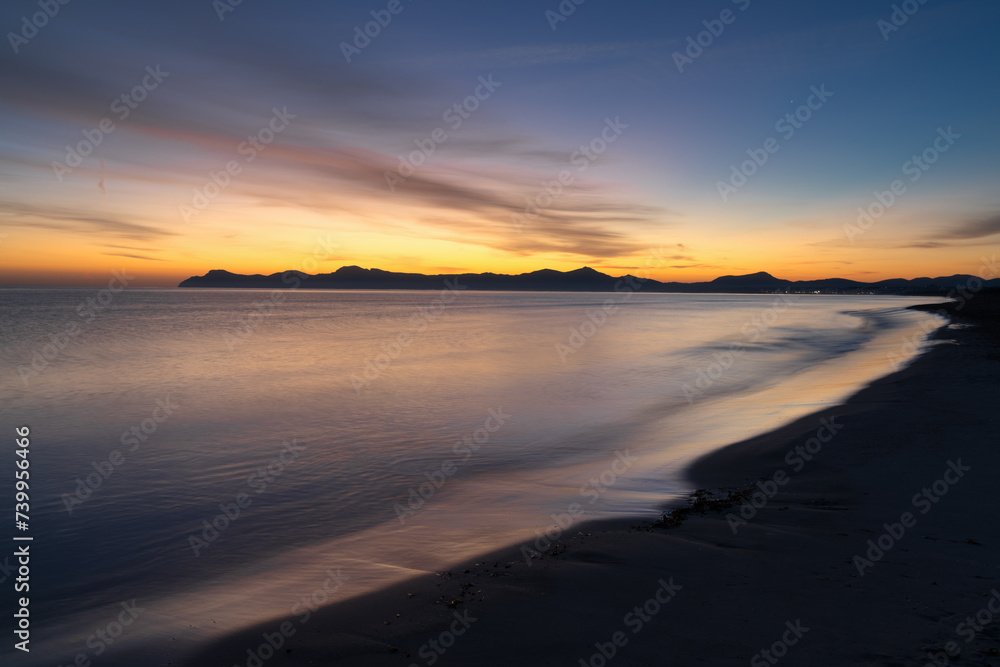 view of the endless beach at Playa del Muro in Alcudia just before sunrise
