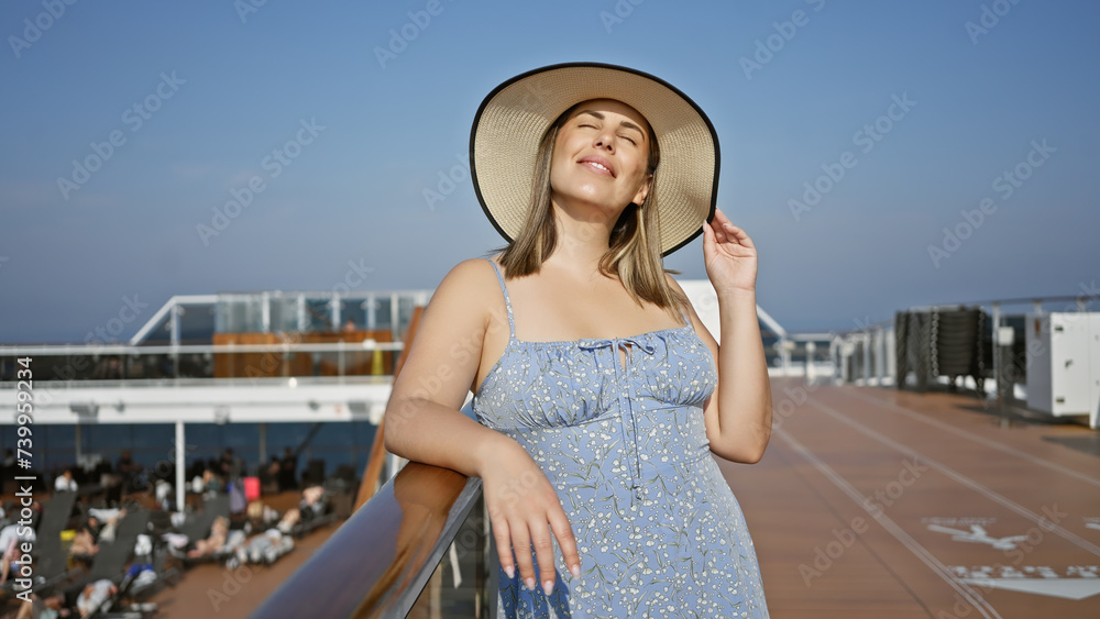 Serene woman enjoying her vacation on a cruise ship's deck under a clear blue sky.