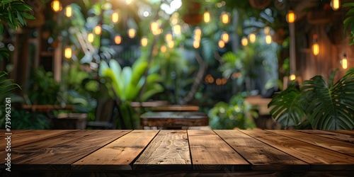 Wooden table top against a blurred background featuring palm trees  jungle scenery  or a tropical caf    coffee shop  bar  or restaurant. Ideal for mock-up templates to showcase your designs.