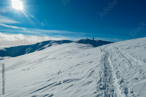 Idyllic snow covered alpine meadow with scenic view of majestic mountain peak Grosser Speikogel in Kor Alps, Lavanttal Alps, Carinthia Styria, Austria. Winter wonderland in Austrian Alps. Ski touring © Chris