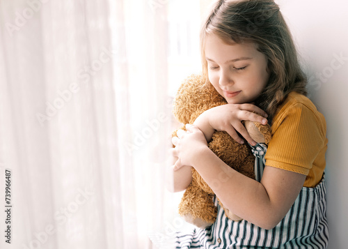 Lovely caucasian girl holding teddy bear,child with toy,smiling happy kid portrait indoors.Happy childhood.Relationship and friendsip.