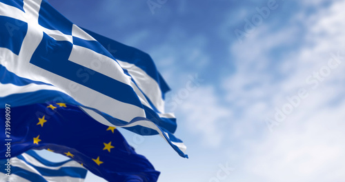 National flags of Greece waving in the wind with flag of the European Union