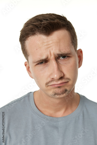 offended frustrated young man on white background. sadness