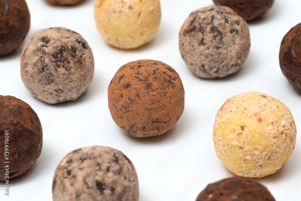 Chocolate truffle candies on a white background, close-up Chocolate truffle candies on a white background, close-up