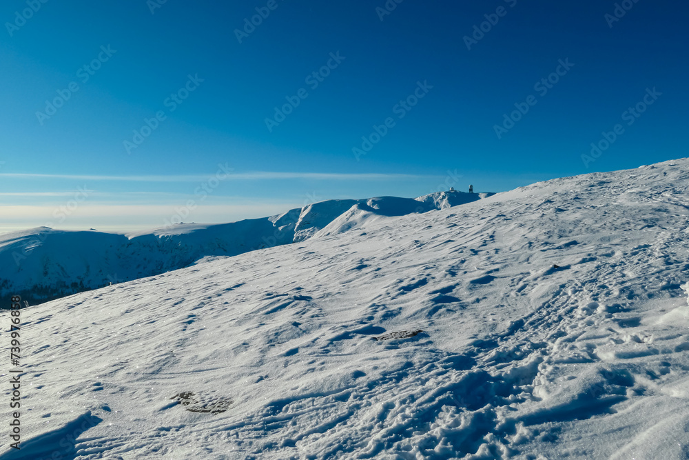 Sun reflection creates shining snow meadow with scenic view of mountain  peak Grosser Speikogel in Kor Alps, Lavanttal Alps, Carinthia Styria, Austria. Winter wonderland in Austrian Alps. Ski touring