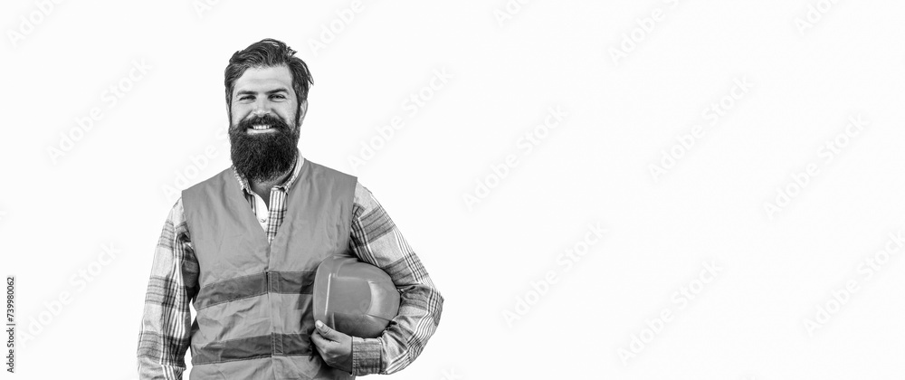 Portrait of a professional heavy industry worker wearing uniform. Bearded man worker with beard in building helmet or hard hat. Portrait of a builder smiling. Man builders, industry.