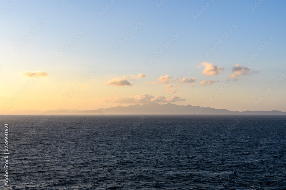 Coast of Costa Rica in dawn light against the background of clouds.