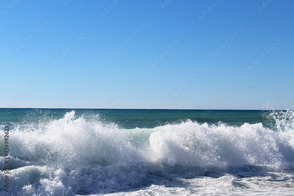 sea waves and foam on the shore of the mediterranean sea.
