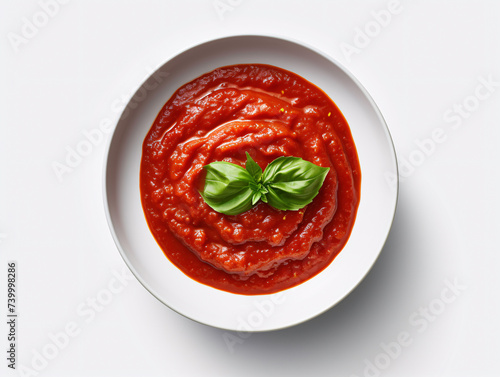 a bowl of red sauce with basil leaves photo