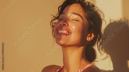 close-up, beauty portrait of a smiling young  woman on beige background with sun shine and shadows , skin care concept, copy space photo