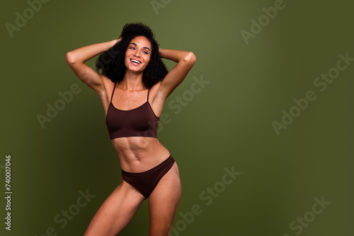 No filter studio photo of dreamy seductive woman wear lingerie hands head enjoy body positive empty space isolated khaki color background
