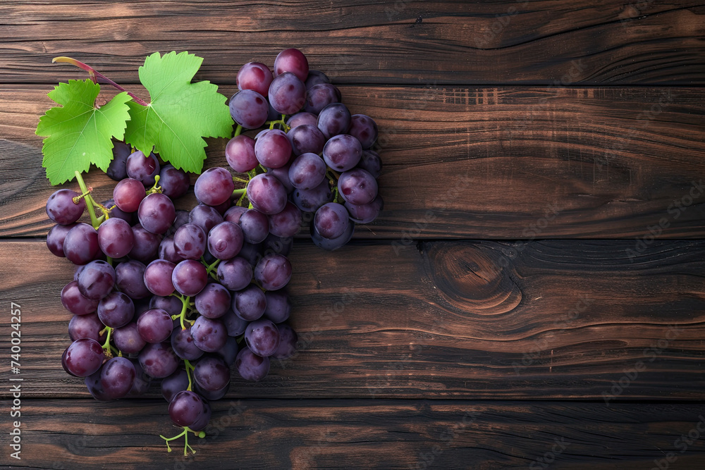 top view a bunch of purple grapes on a wooden background top view a bunch of purple grapes on a wooden background