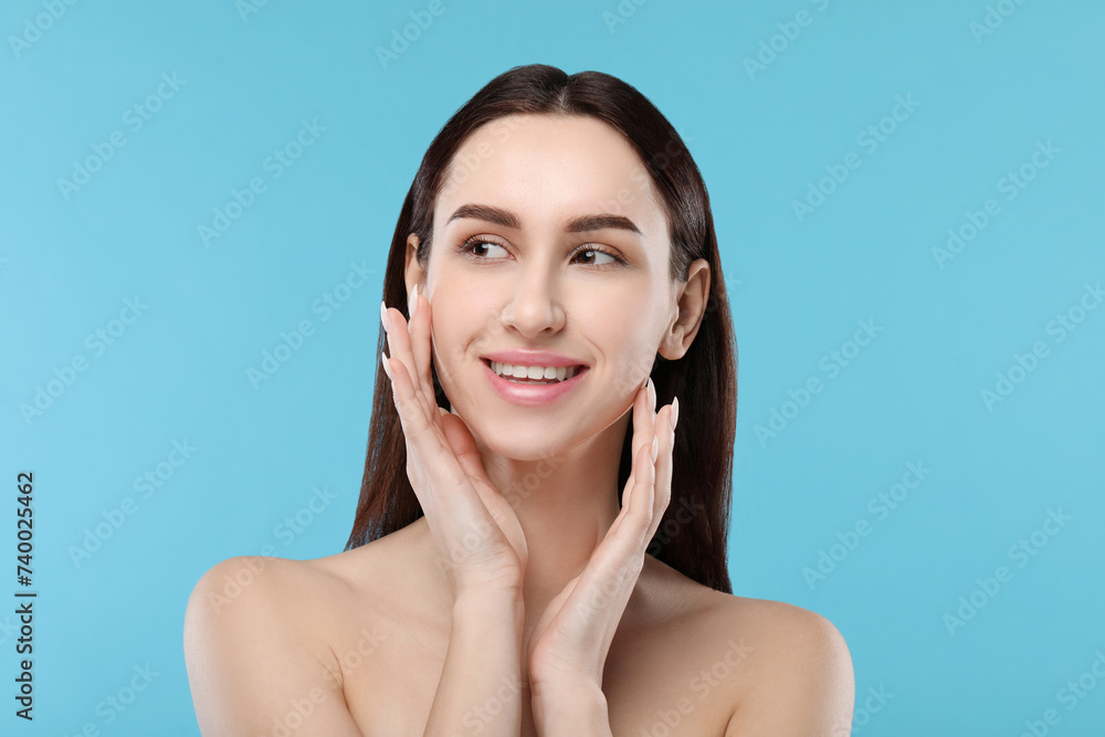 Portrait of beautiful young woman on light blue background Portrait of beautiful young woman on light blue background