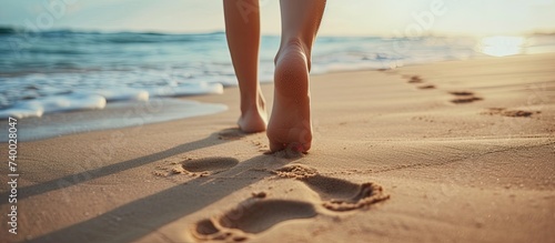 A closeup shot capturing the footprints left by a person walking on a sandy beach during their beach travel.