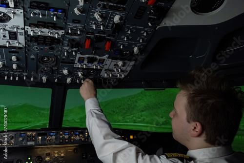 Man aviator carefully adjusts parameters on control panel. Pilot maintains peak performance and optimize aircraft functionality