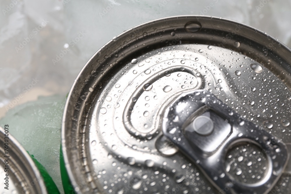 Energy drinks in wet cans and ice cubes, closeup Energy drinks in wet cans and ice cubes, closeup