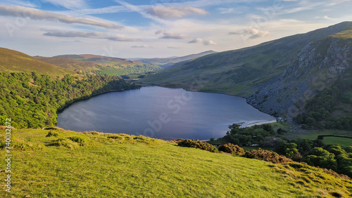 Serene beauty unfolds at Lough Tay, where the mirrored waters reflect the tranquility of the Wicklow Mountains in Ireland. © Ross