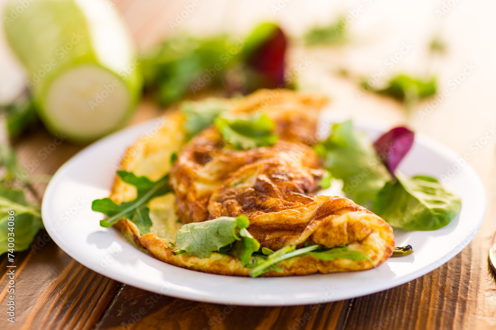 cooked fried omelets with zucchini and herbs cooked fried omelets with zucchini and herbs