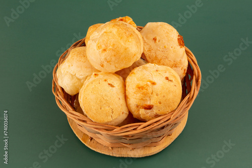 Cheese bread (Brazilian pao de queijo mineiro) in front view, clean background wooden basket photo