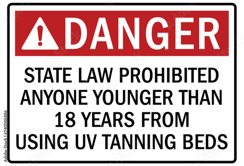 Ultraviolet warning sign and labels state law prohibited anyone younger than 18 years from using UV tanning beds