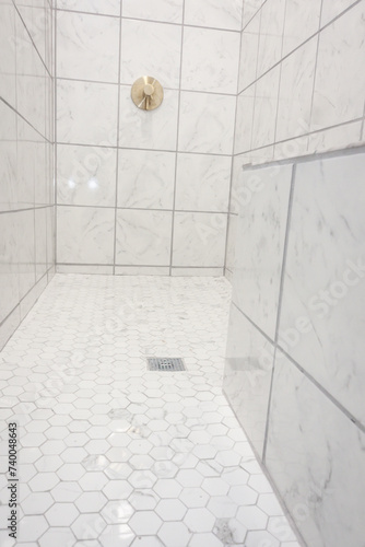 White and gray marbled tile large empty recently renovated home shower in a master bathroom