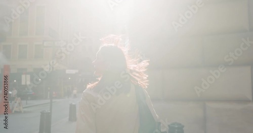 Medium shot of attractive female strolling in vivid urban New York City on bright sunny day.
