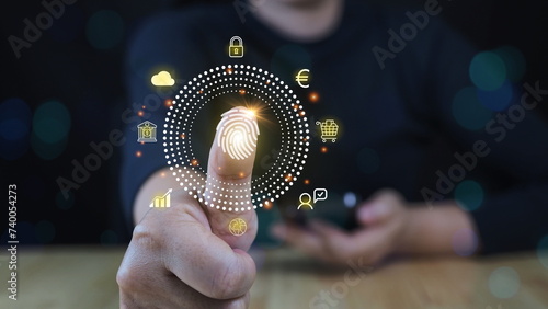 Woman using thumb to scan finger print or for digital processing biometric identification to access security system includes internet banking, cloud system and mobile phone , Cyber security concept.