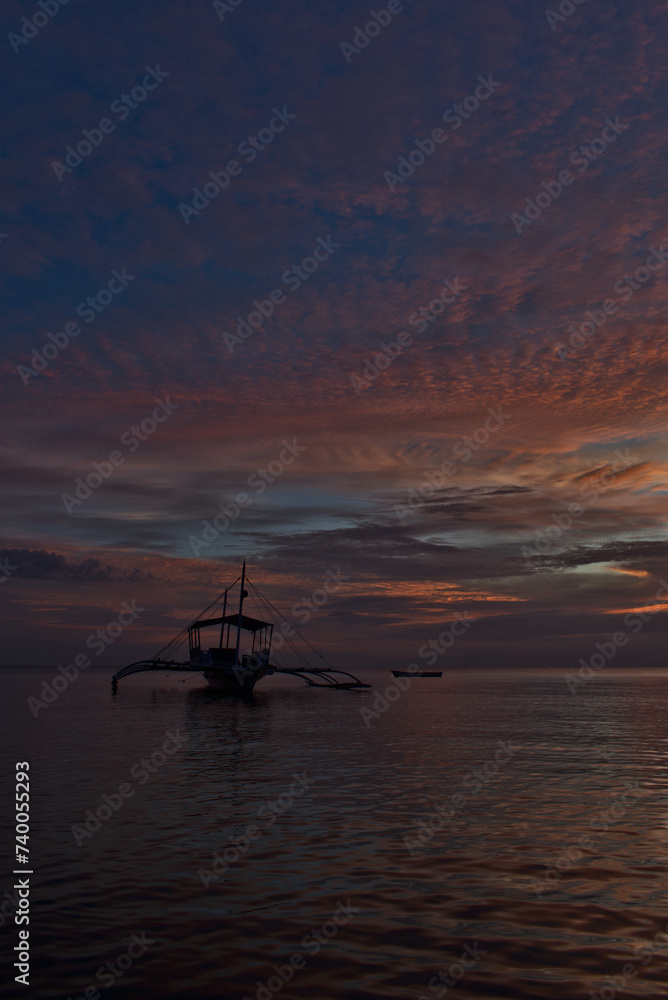 Bangka boat in Moalboal, Philippines, during the sunset (gold hour)