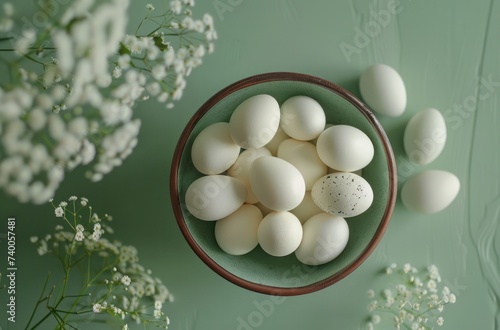 easter eves with flowers on a green table and white eggs