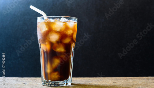 Glass of ice coffee on black background