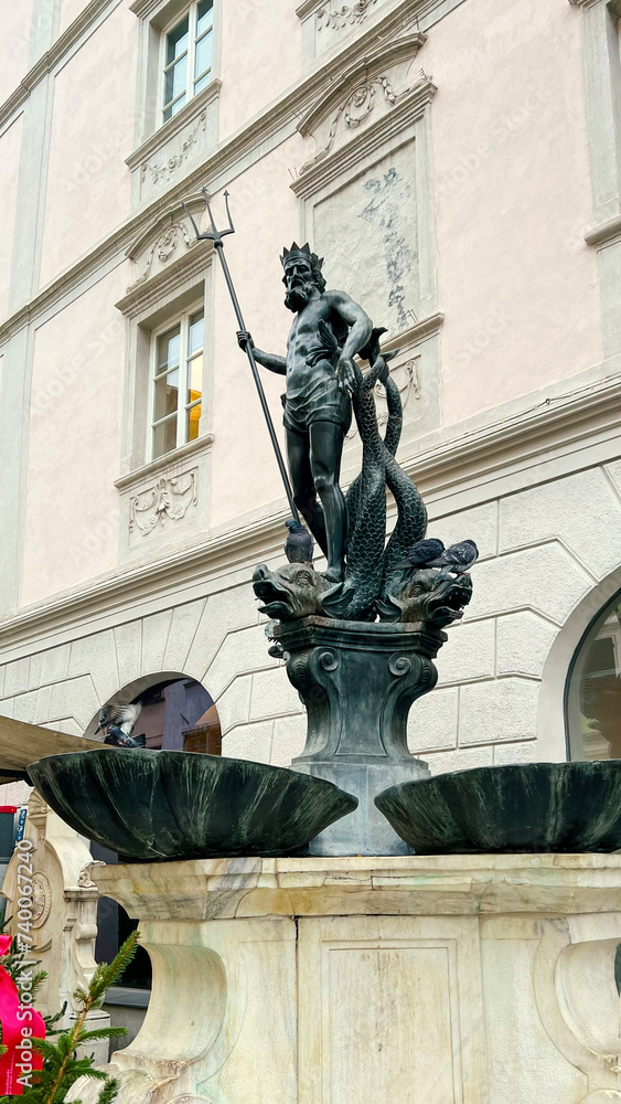 Fountain Statue of Neptune on a city street in the old part of Bolzano, Italy. Vertical photo.Fountain Statue of Neptune on a city street in the old part of Bolzano, Italy. Vertical photo.