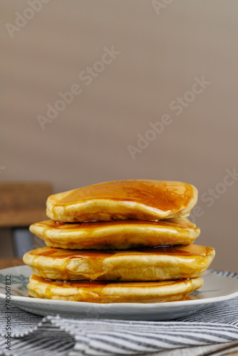 A stack of pancakes with honey on a vintage plate on the table. Breakfast. (ID: 740067832)