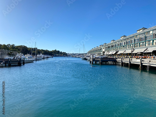 View of the port country with moored boats. Apartments in rows near a marina dock. Buildings and a quay in a harbour district. photo