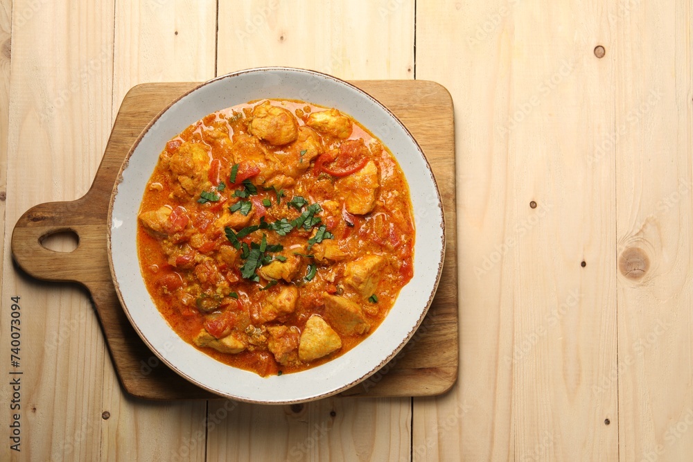 Delicious chicken curry on wooden table, top view. Space for text Delicious chicken curry on wooden table, top view. Space for text
