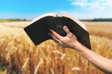 Human hands of prayer hold bible book