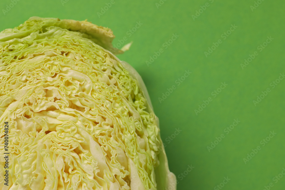Obraz premium Cut fresh Chinese cabbage on light green background, top view. Space for text